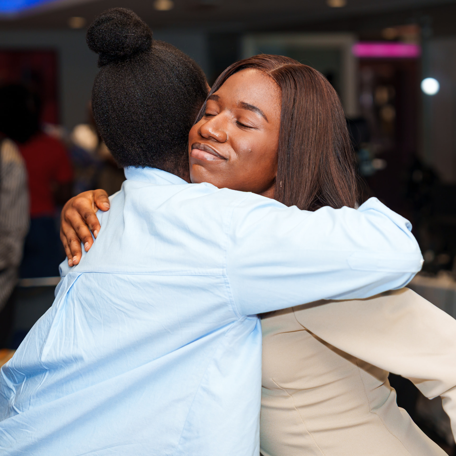 Two women embracing at a Christian in Corporate gathering